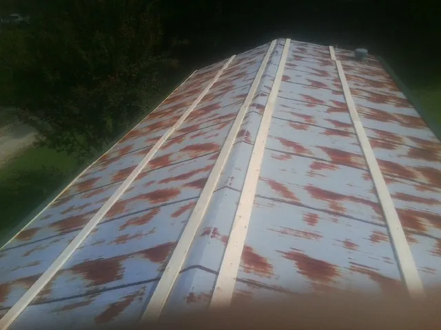 Rusted metal roof panels with new wood purlins before replacement — Storm Damage Roof Repair in Harvey by Roofing Brothers