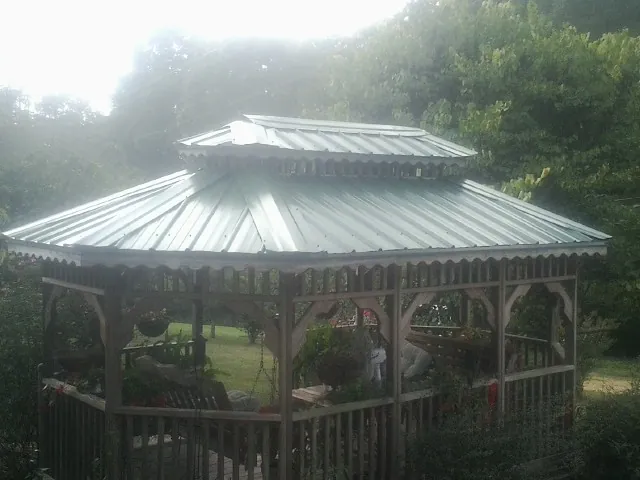 Two tier green metal roof on a garden gazebo in Harvey